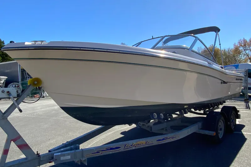 Slide: The Image of 2014 Grady-White Freedom 225 boat on trailer, side view under clear blue sky. - 5