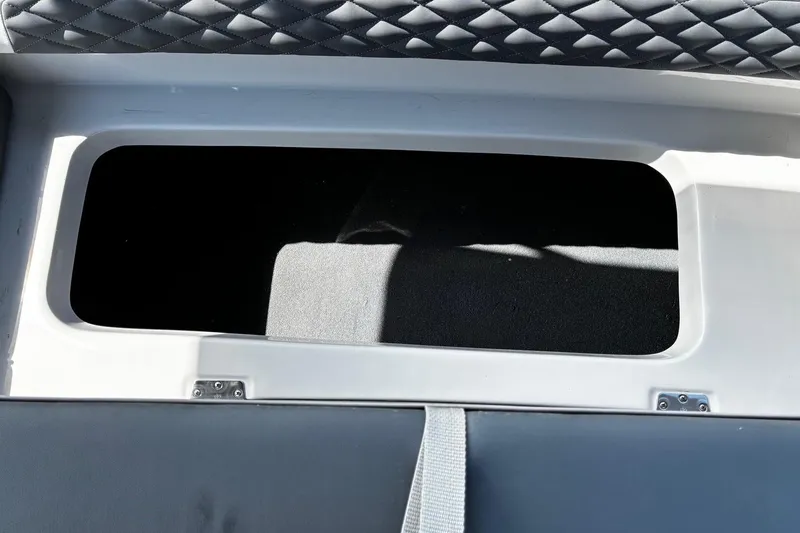 Slide: The Image of Storage compartment in 2026 Starcraft SVX 191 OB boat, featuring quilted upholstery. - 9