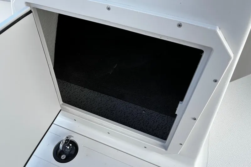 Slide: The Image of Storage compartment on 2026 Starcraft SVX 191 OB boat, featuring a sleek white interior. - 11