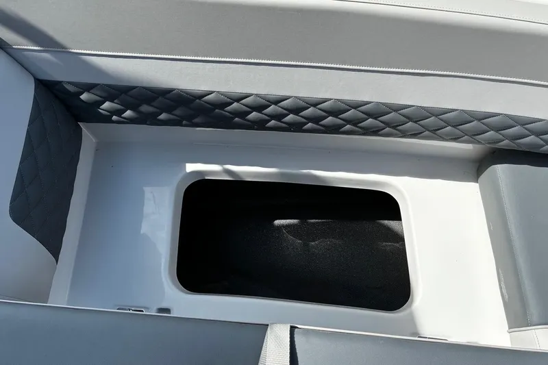 Slide: The Image of Interior storage compartment of 2026 Starcraft SVX 191 OB boat with quilted upholstery. - 17