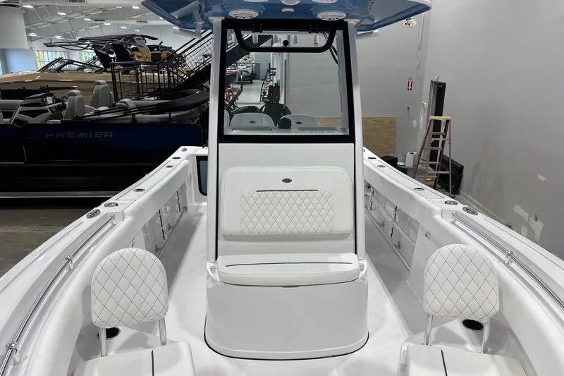 Slide: The Image of 2025 Sportsman Open 232 Center Console boat interior with white seating and modern design. - 6