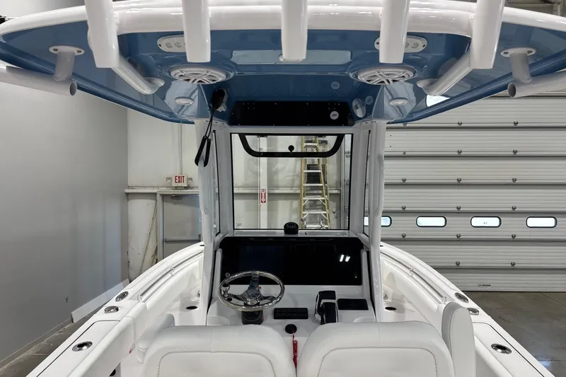 Slide: The Image of 2025 Sportsman Open 232 Center Console boat interior with steering wheel and controls. - 9