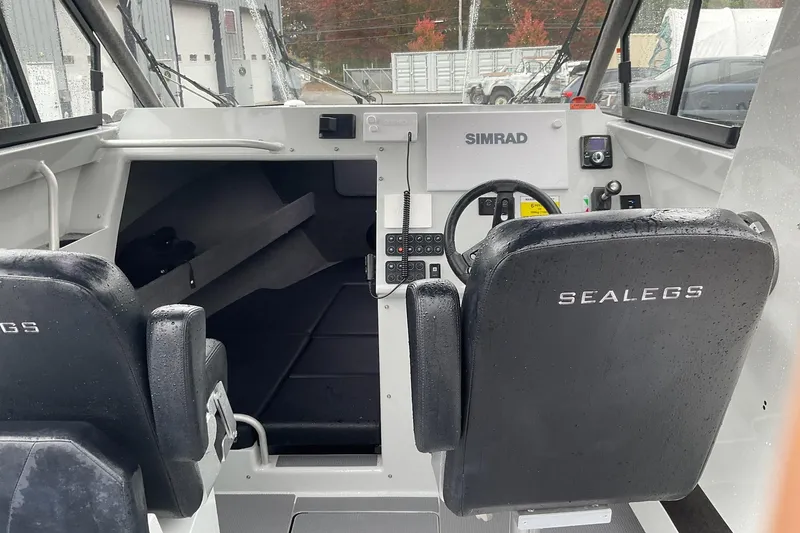 Slide: The Image of 2023 Sealegs 8.5 Alloy Cabin interior with Simrad navigation system and black seating. - 13