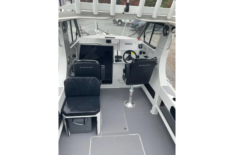 Slide: The Image of Interior of 2023 Sealegs 8.5 Alloy Cabin boat with steering wheel and seating. - 14