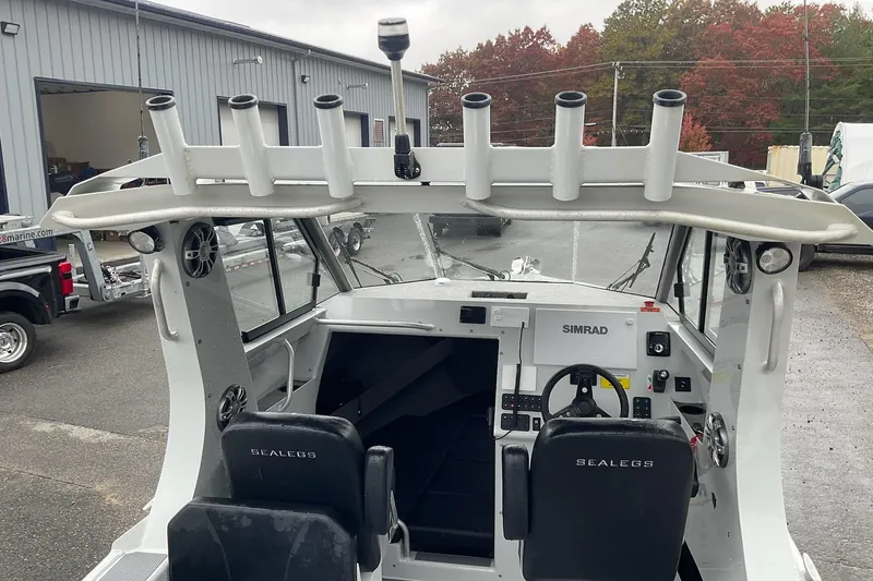 Slide: The Image of 2023 Sealegs 8.5 Alloy Cabin boat interior with steering console and rod holders. - 5