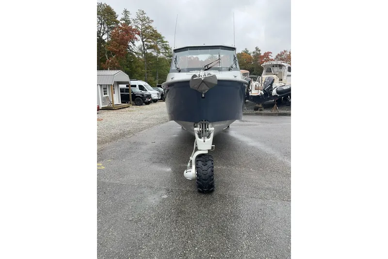 Slide: The Image of 2023 Sealegs 8.5 Alloy Cabin boat with amphibious wheels on a wet surface. - 7