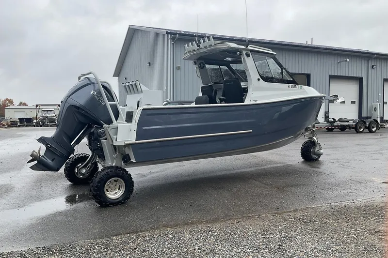 Slide: The Image of 2023 Sealegs 8.5 Alloy Cabin boat with wheels, parked outside a warehouse. - 8