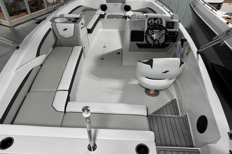 Slide: The Image of 2026 Starcraft SVX 191 OB boat interior with modern seating and steering console. - 8