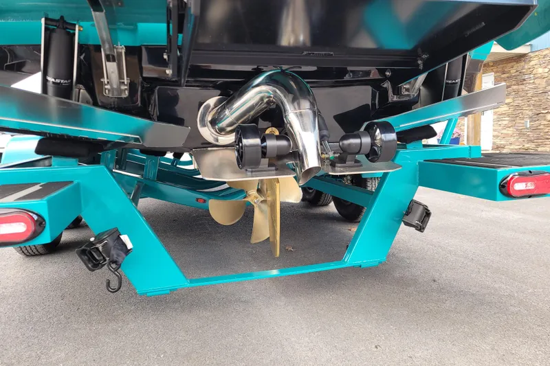 Slide: The Image of 2026 Supra SL boat trailer with propeller and exhaust system, teal color. - 13
