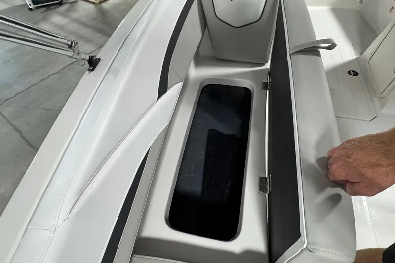 Slide: The Image of 2026 Starcraft SVX 191 OB boat seat storage compartment with open lid, showcasing interior space. - 19
