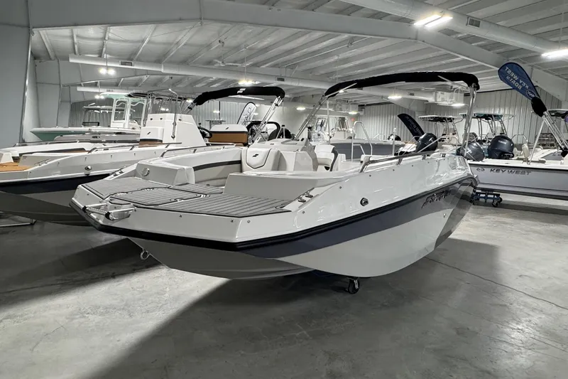 Slide: The Image of 2026 Starcraft SVX 191 OB boat displayed in a showroom, featuring sleek design and modern amenities. - 3