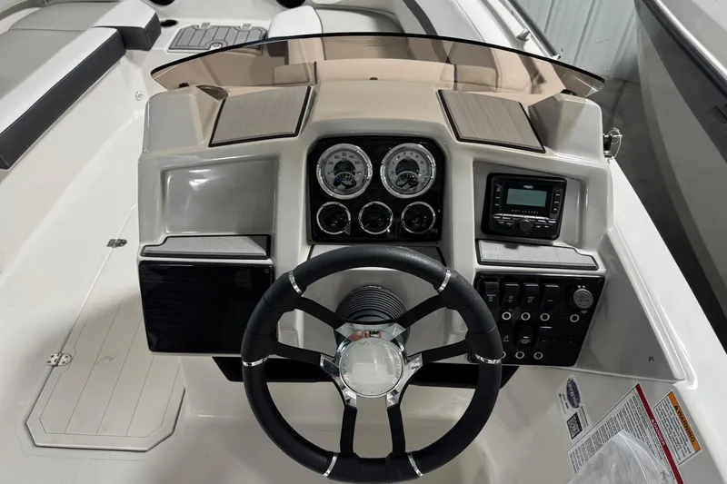 Slide: The Image of 2026 Starcraft SVX 191 OB boat dashboard with steering wheel and control panel. - 10