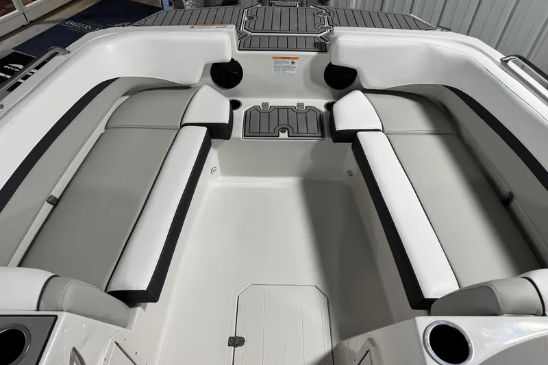 Slide: The Image of 2026 Starcraft SVX 191 OB boat interior with white and gray seating, cup holders, and storage compartments. - 11
