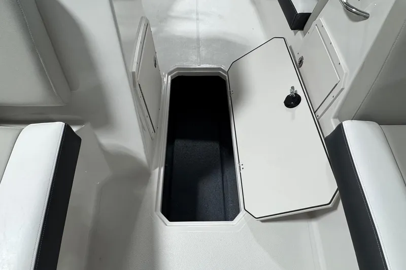 Slide: The Image of 2026 Starcraft SVX 191 OB boat interior storage compartment with open hatch. - 16