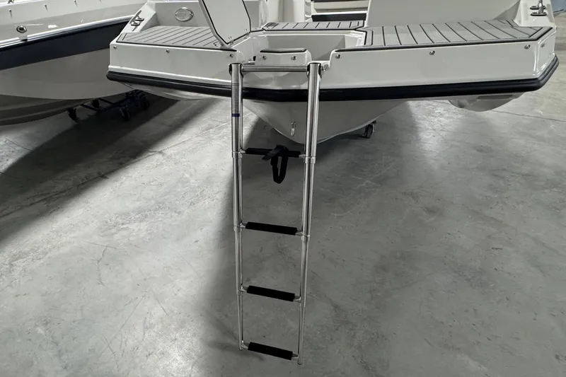 Slide: The Image of 2026 Starcraft SVX 191 OB boat with extended swim ladder on concrete floor. - 5