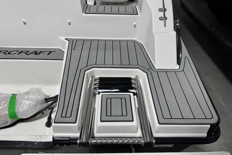 Slide: The Image of 2026 Starcraft SVX 191 OB boat deck with foldable ladder and sleek design. - 7
