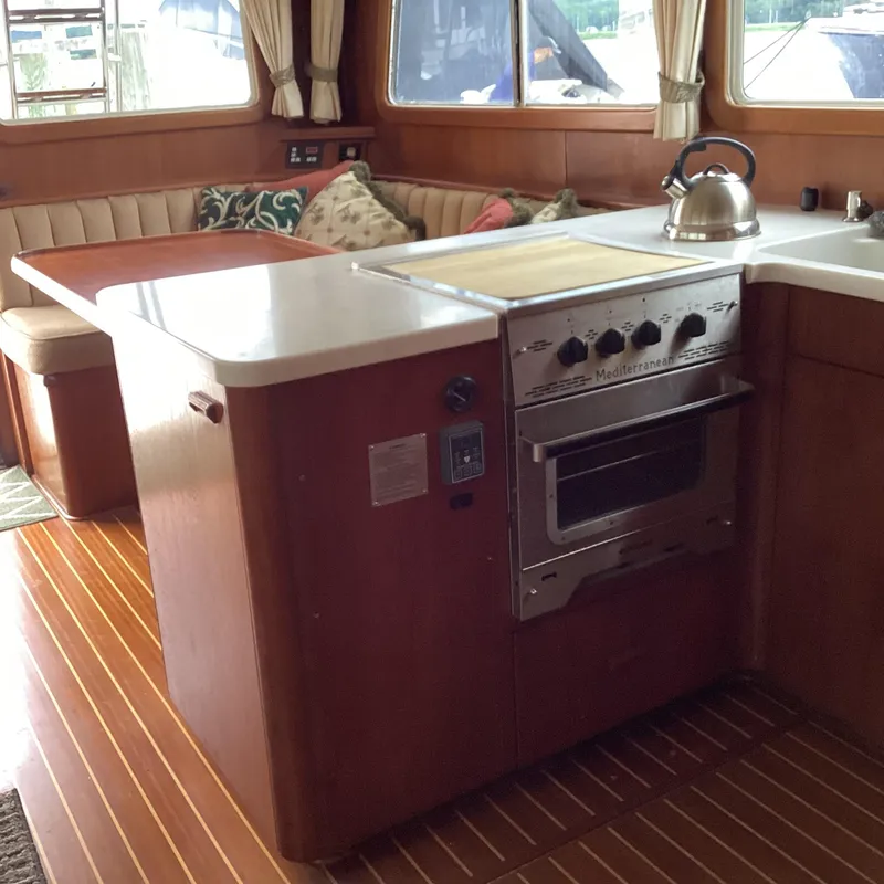 Slide: The Image of Interior of 1991 MDI Sedan Flybridge with kitchen and seating area. - 10