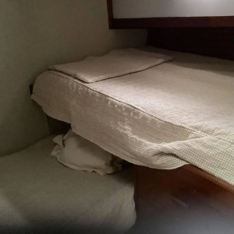 Slide: The Image of Cozy cabin bed in 1991 MDI Sedan Flybridge with beige bedding. - 14