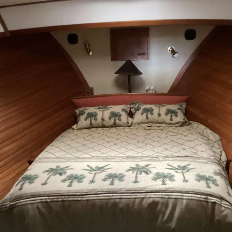 Slide: The Image of Cozy cabin bedroom in 1991 MDI Sedan Flybridge with palm tree bedding. - 16