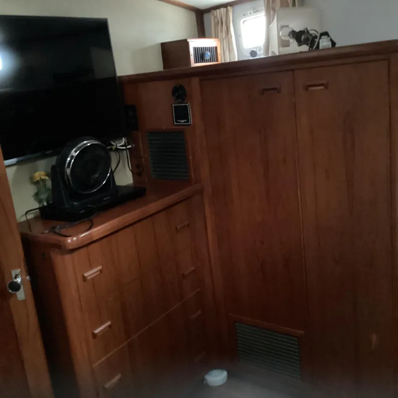 Slide: The Image of Interior of 1991 MDI Sedan Flybridge with wooden cabinetry and mounted TV. - 21