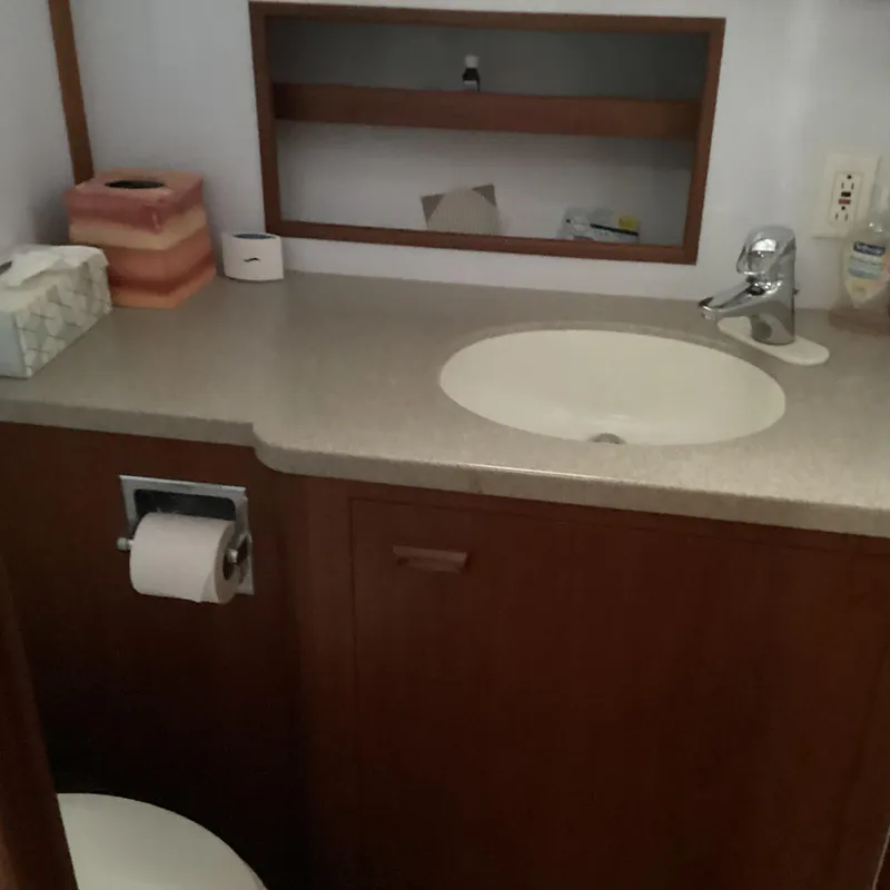 Slide: The Image of Bathroom vanity with sink and storage in 1991 MDI Sedan Flybridge. - 23
