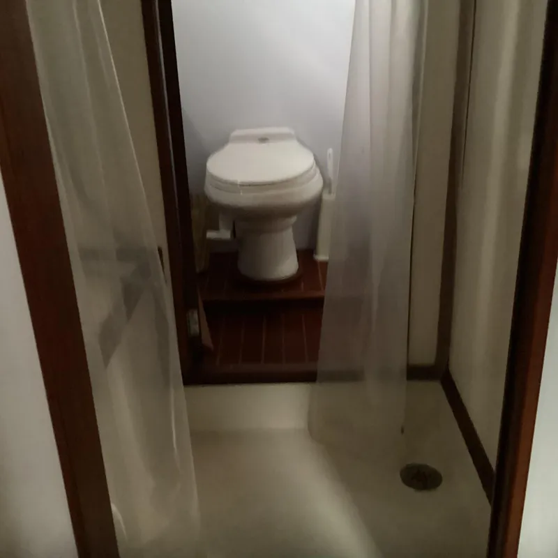 Slide: The Image of Compact bathroom with toilet and shower in 1991 MDI Sedan Flybridge. - 25