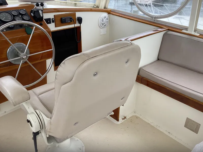 Slide: The Image of Interior of 1991 MDI Sedan Flybridge with steering wheel and seating area. - 35