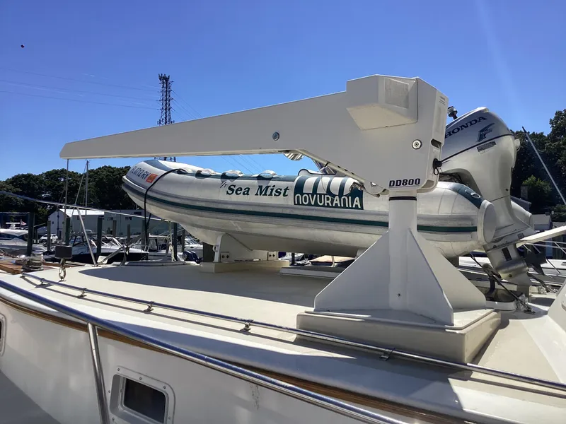 Slide: The Image of 1991 MDI Sedan Flybridge with Novurania Sea Mist dinghy on deck. - 41