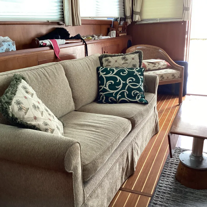 Slide: The Image of Cozy interior of 1991 MDI Sedan Flybridge with beige sofa and decorative pillows. - 9