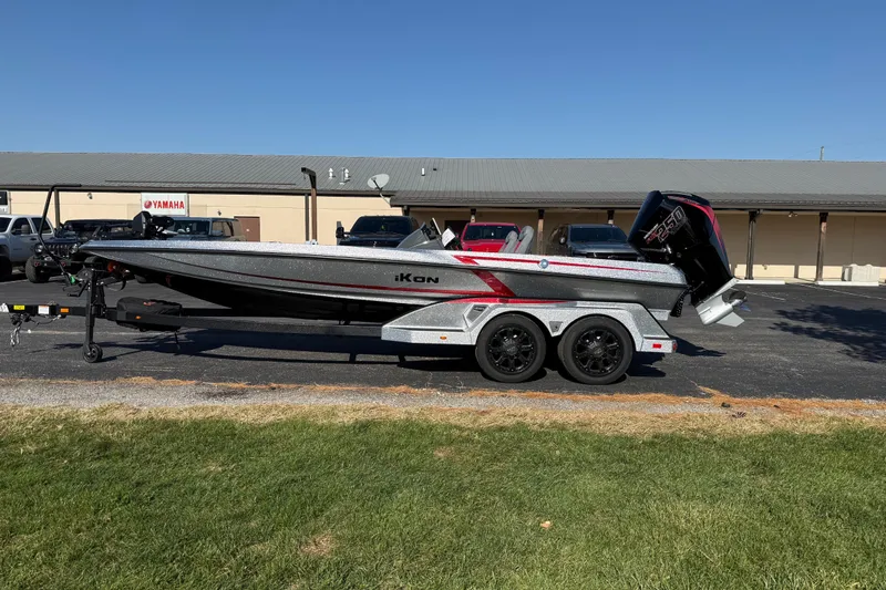 The Image of 2026 iKon LXE21 boat on trailer, parked outdoors near Yamaha dealership. - 1