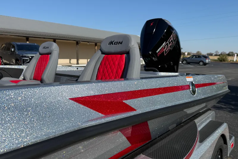 Slide: The Image of 2026 iKon LXE21 boat with red seats and powerful outboard motor. - 12