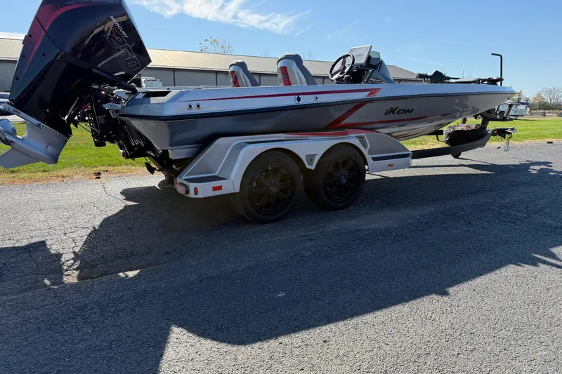 Slide: The Image of 2026 iKon LXE21 boat on trailer, sleek design, dual motors, sunny day. - 5