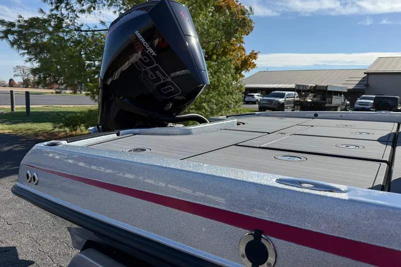 Slide: The Image of 2026 iKon LXE21 boat with Mercury engine, parked outdoors on a sunny day. - 6