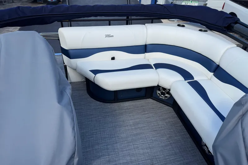 Slide: The Image of Luxurious seating on 2026 JC 23 Neptoon TT Sport pontoon boat, featuring blue and white upholstery. - 12