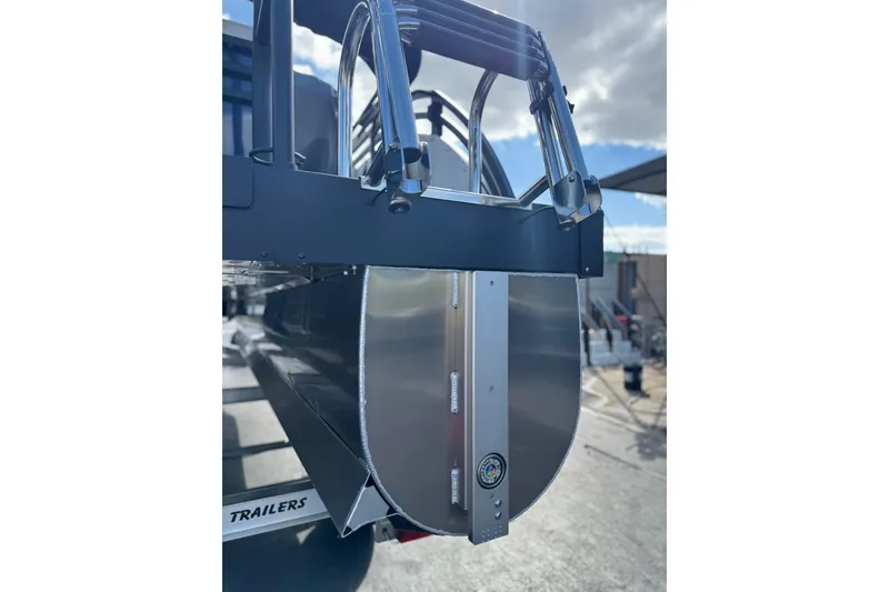 Slide: The Image of 2026 JC 23 Neptoon TT Sport pontoon boat rear view with ladder and trailer. - 17