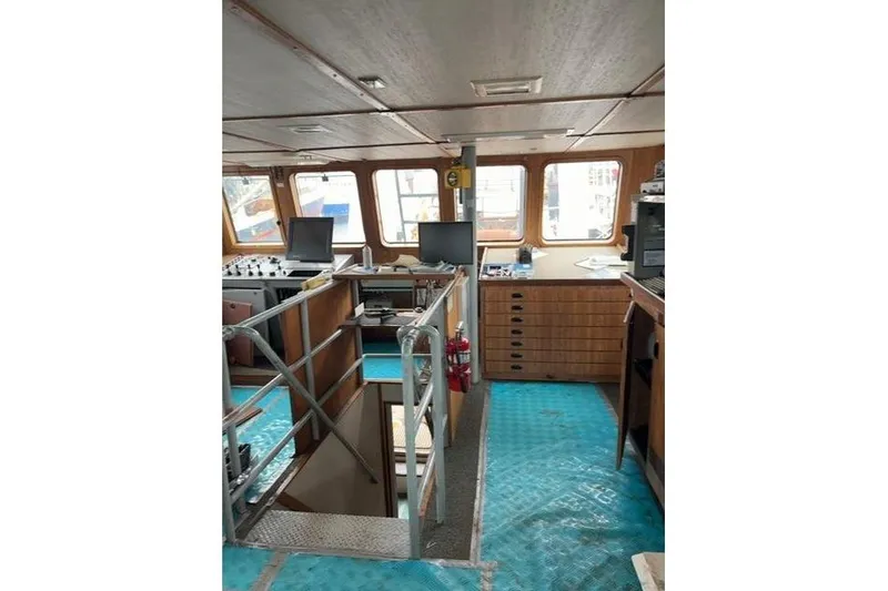 Slide: The Image of Interior of 1976 Halter Custom Built Mid-Water Trawler, featuring navigation equipment and control panels. - 12