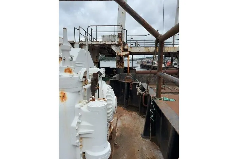 Slide: The Image of Rusty deck of a 1976 Halter Custom Built Mid-Water Trawler, showing machinery and railing. - 14