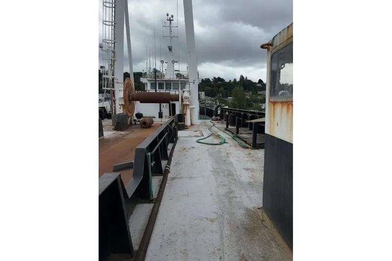 Slide: The Image of Deck view of a 1976 Halter Custom Built Mid-Water Trawler, featuring fishing equipment. - 5
