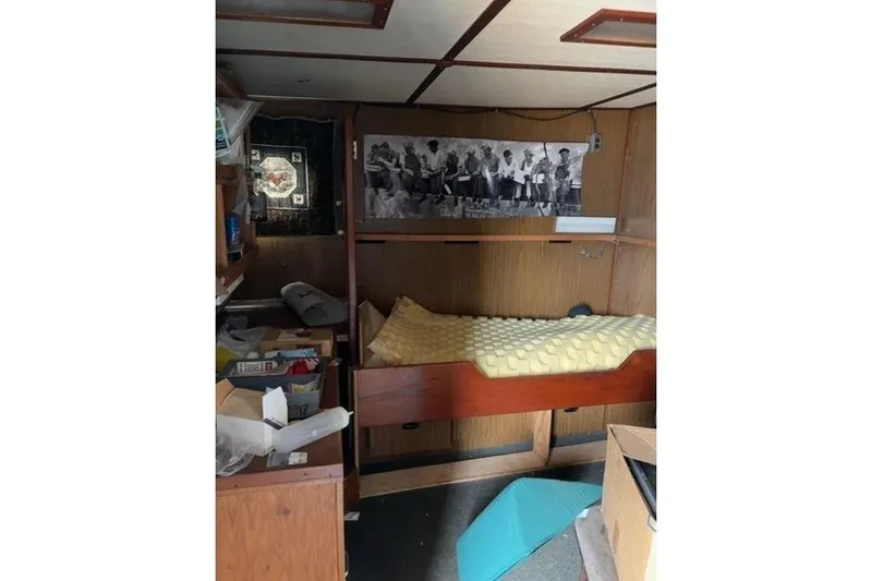 Slide: The Image of Interior of a 1976 Halter Custom Built Mid-Water Trawler, featuring a bunk bed and storage. - 9