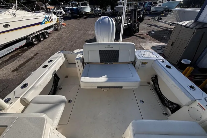 Slide: The Image of 2025 Cobia 240 Dual Console boat interior with seating and storage compartments. - 10