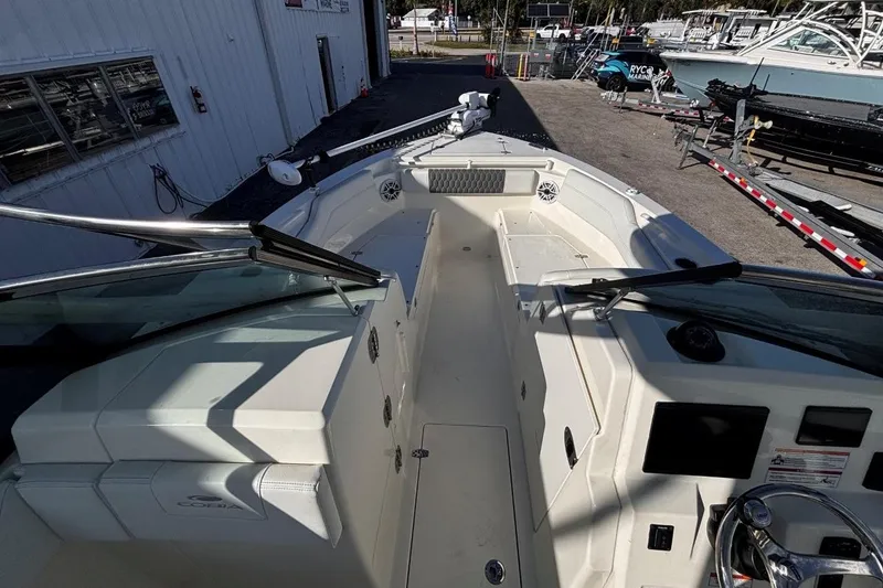 Slide: The Image of 2025 Cobia 240 Dual Console boat interior, featuring spacious seating and modern controls. - 13