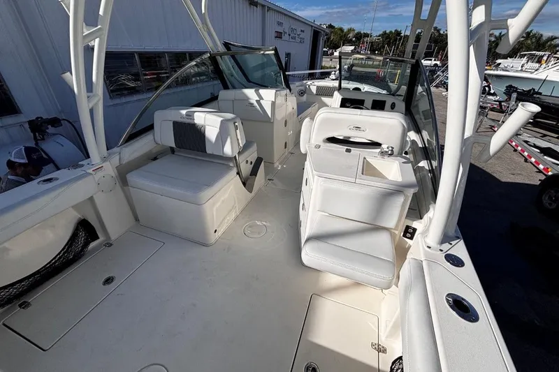 Slide: The Image of 2025 Cobia 240 Dual Console boat interior with white seating and modern design. - 9