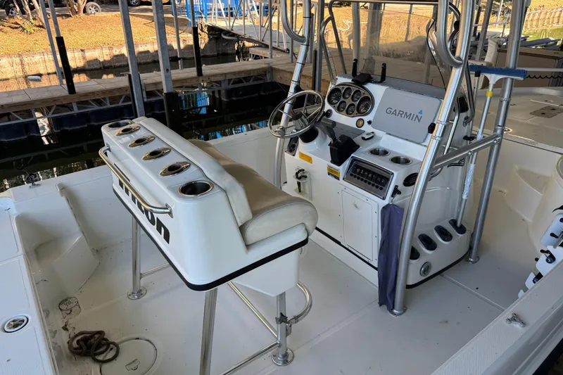 Slide: The Image of 2003 Triton 220 LTS boat interior with Garmin navigation system and fishing rod holders. - 6