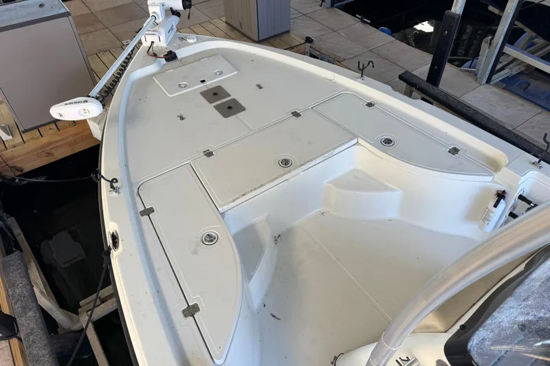 Slide: The Image of 2003 Triton 220 LTS boat deck with storage compartments and trolling motor. - 9