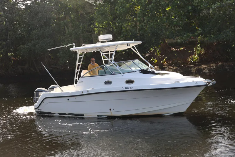 The Image of 2012 Robalo R305 Walkaround boat cruising on a calm river. - 0