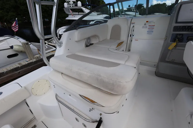 Slide: The Image of 2012 Robalo R305 Walkaround boat interior with white seating and control panel. - 10