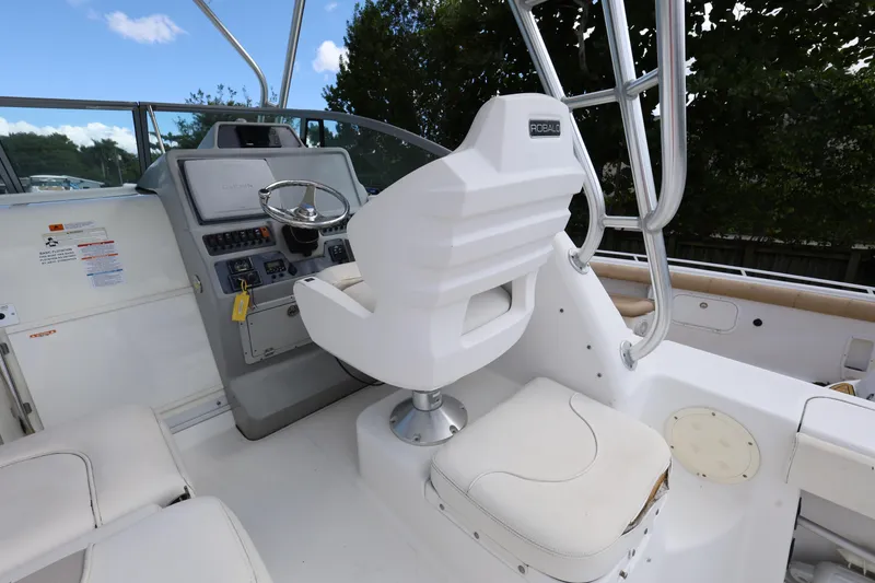 Slide: The Image of 2012 Robalo R305 Walkaround boat helm with steering wheel and captain's chair. - 11