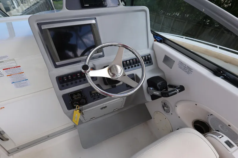 Slide: The Image of 2012 Robalo R305 Walkaround helm with steering wheel and control panel. - 12