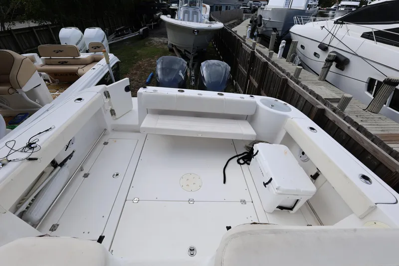 Slide: The Image of 2012 Robalo R305 Walkaround boat interior with seating and storage compartments. - 14