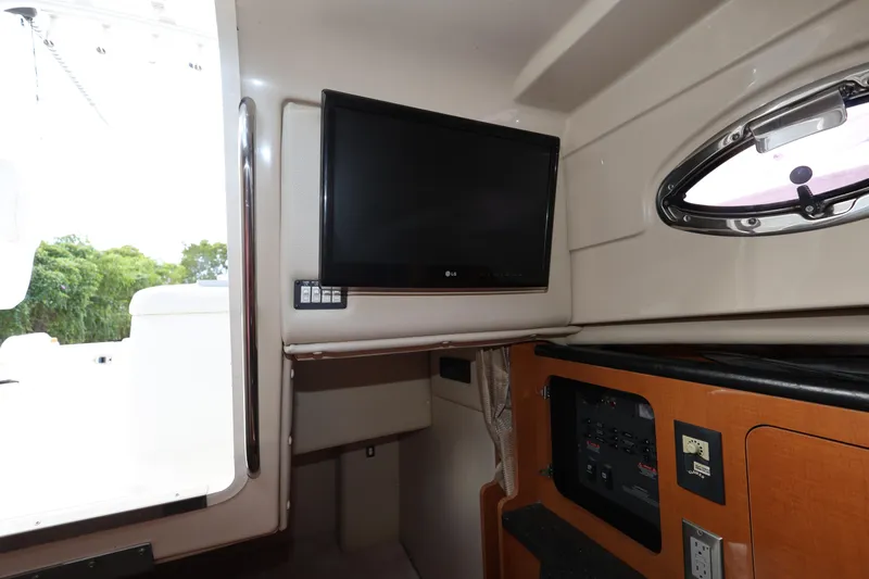 Slide: The Image of Interior of 2012 Robalo R305 Walkaround boat with TV and control panel. - 20